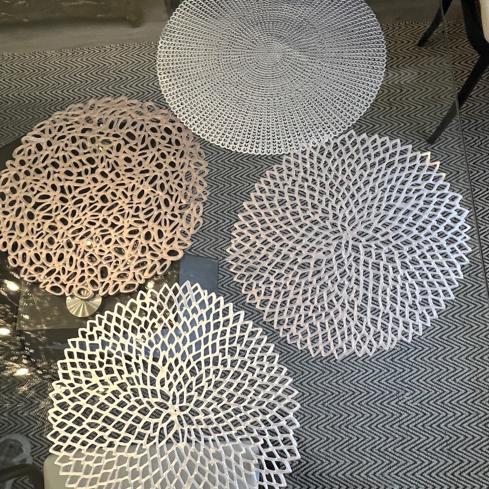 Chilewich place settings, laser-cut, perforated, organic shapes, in silver.